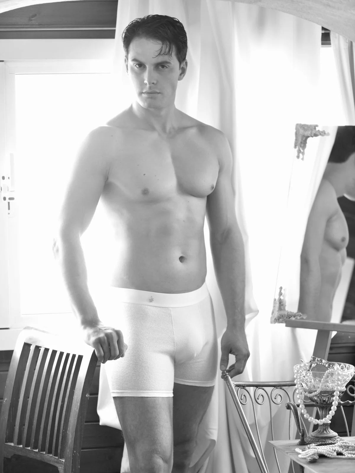 Backlit men’s campaign study in the interior.